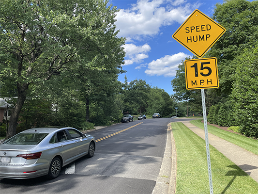 Car traveling over a speed hump on Fairway Drive
