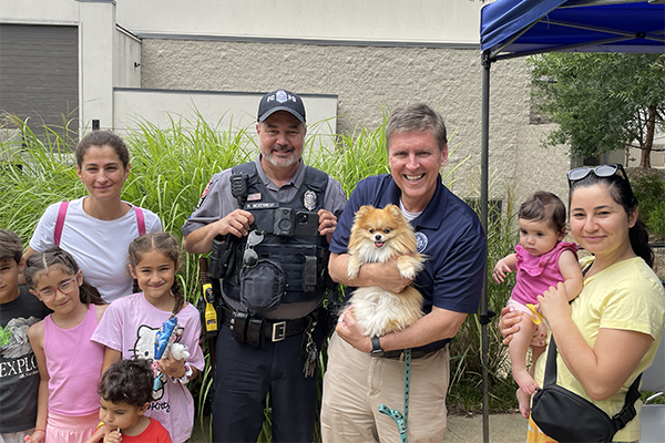 Supervisor Walter Alcorn with police officers at National Night Out at Hunters Woods