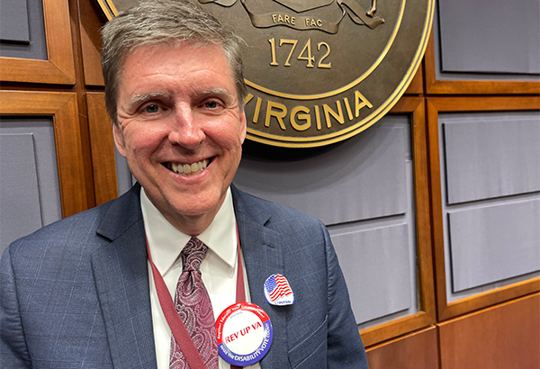 Supervisor Walter Alcorn wearing a voted sticker and button for REV Up