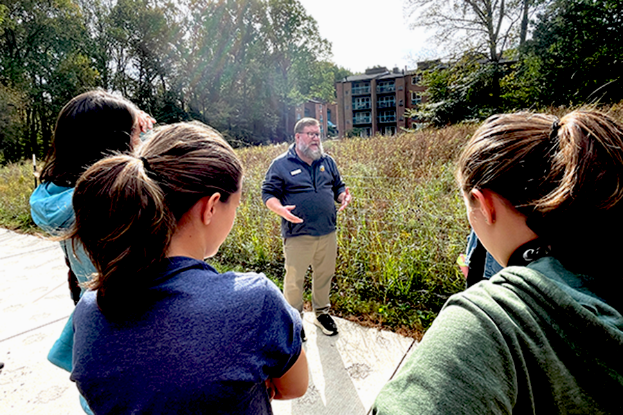 Reston Association staff gives talk to a group at the native meadow near Reston Community Center Hunters Woods