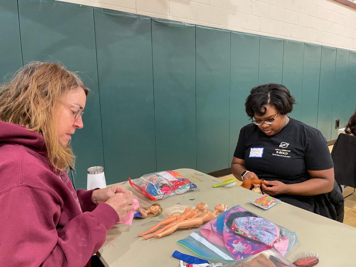 Sorting Barbies and summer toys at the 2025 MLK event at Cathy Hudgins Community Center