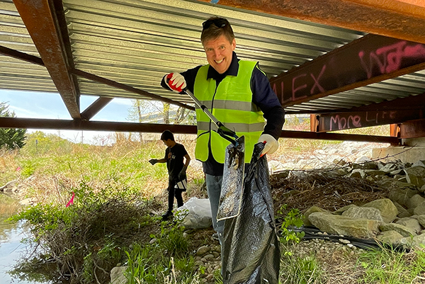 Fairfax County Supervisor Walter Alcorn picking up trash during the Tysons Forest Cleanup