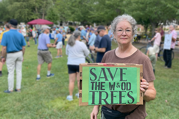 Woman holding a save the W&OD Trail trees sign