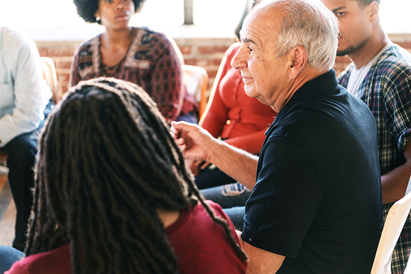 Diverse group of people sitting in a circle talking