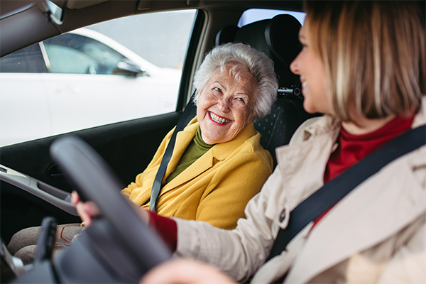 Woman driving a senior to an appointment