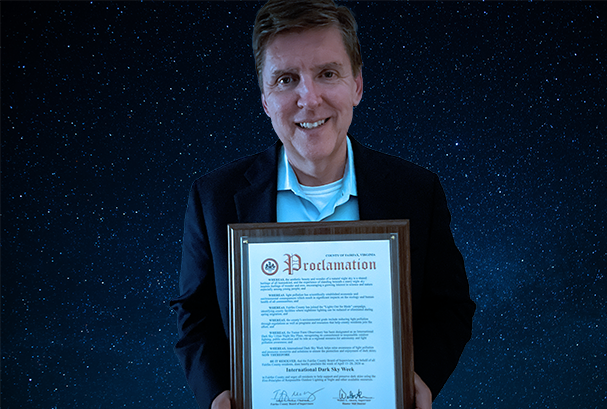 Fairfax County Supervisor Walter Alcorn holding the International Dark Skies 2026 proclamation