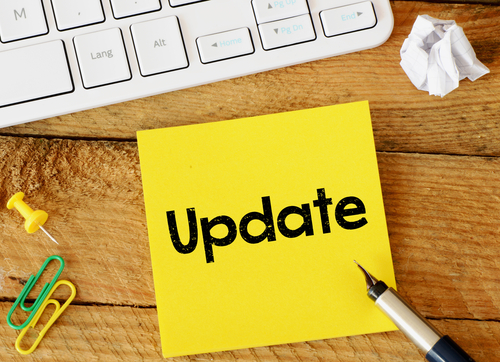 Update Update sticker with marketing plan inscription over computer keyboard