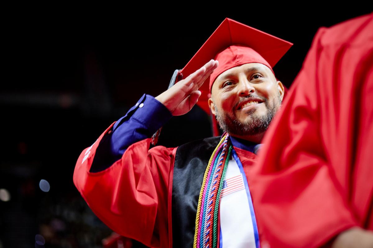 A US military UNLV graduate salutes at graduation
