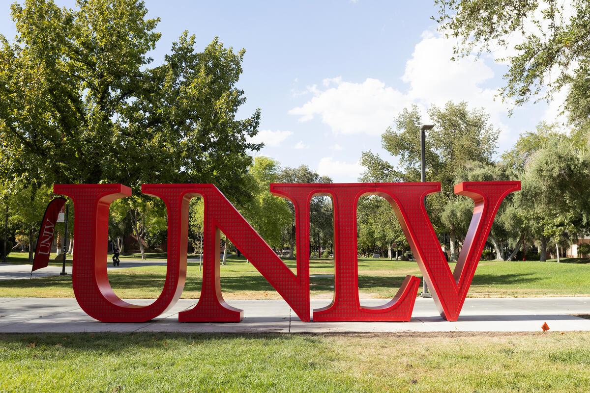The new UNLV letters bright red in front of trees