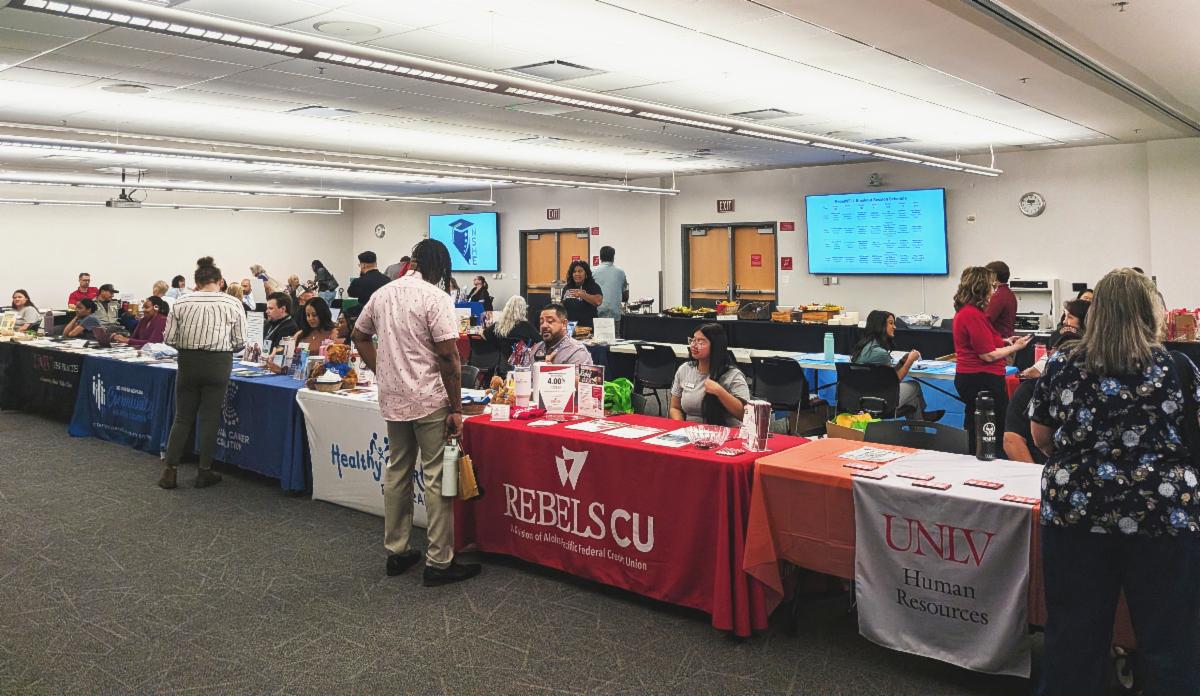 Scene from 2026 Open Enrollment & Wellness Fair featuring tables with health vendors and UNLV employee participants