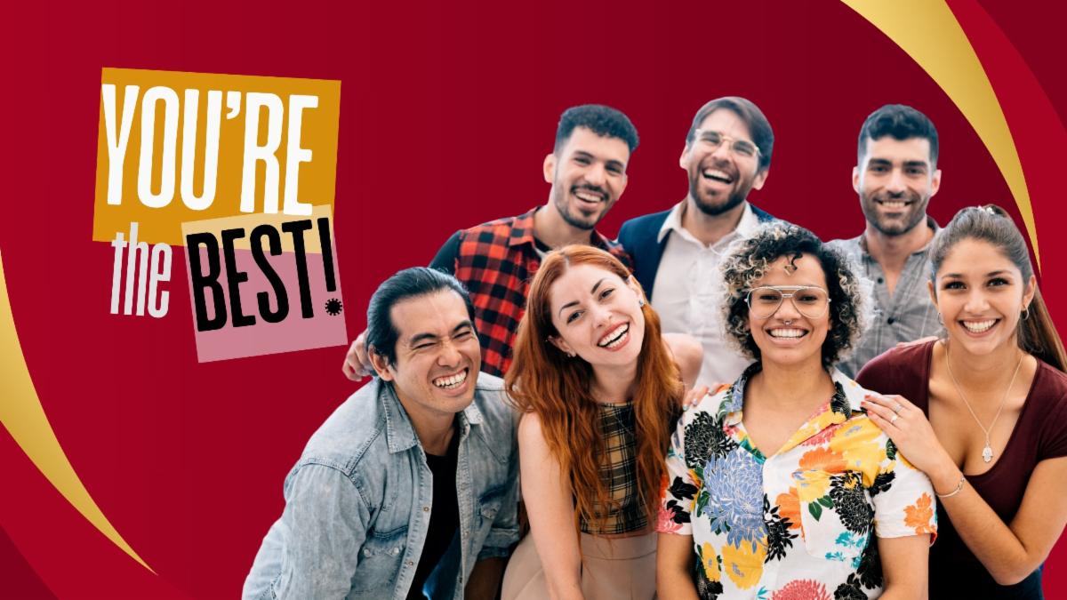 Group of men and women smiling against a red background