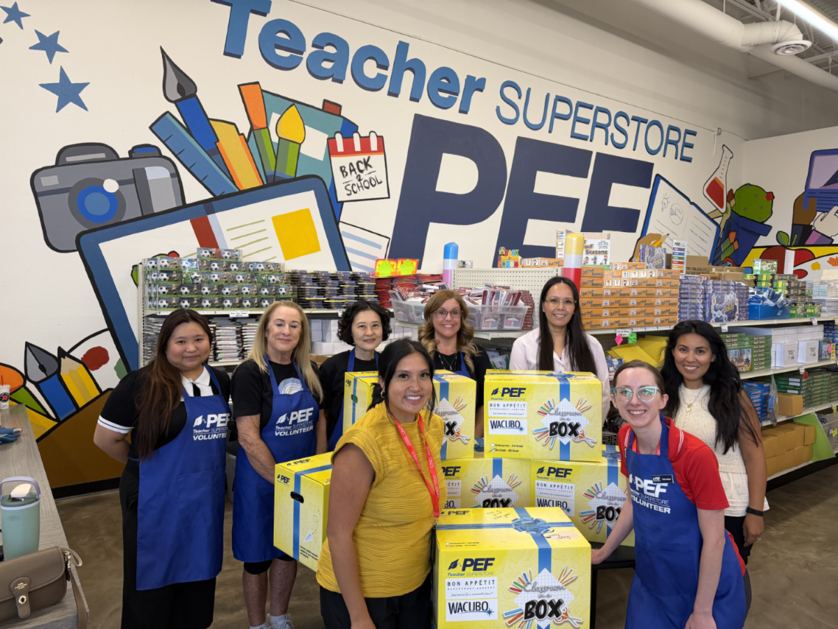 Group of Business Affairs employees in front of a a selection of packed CIAB boxes