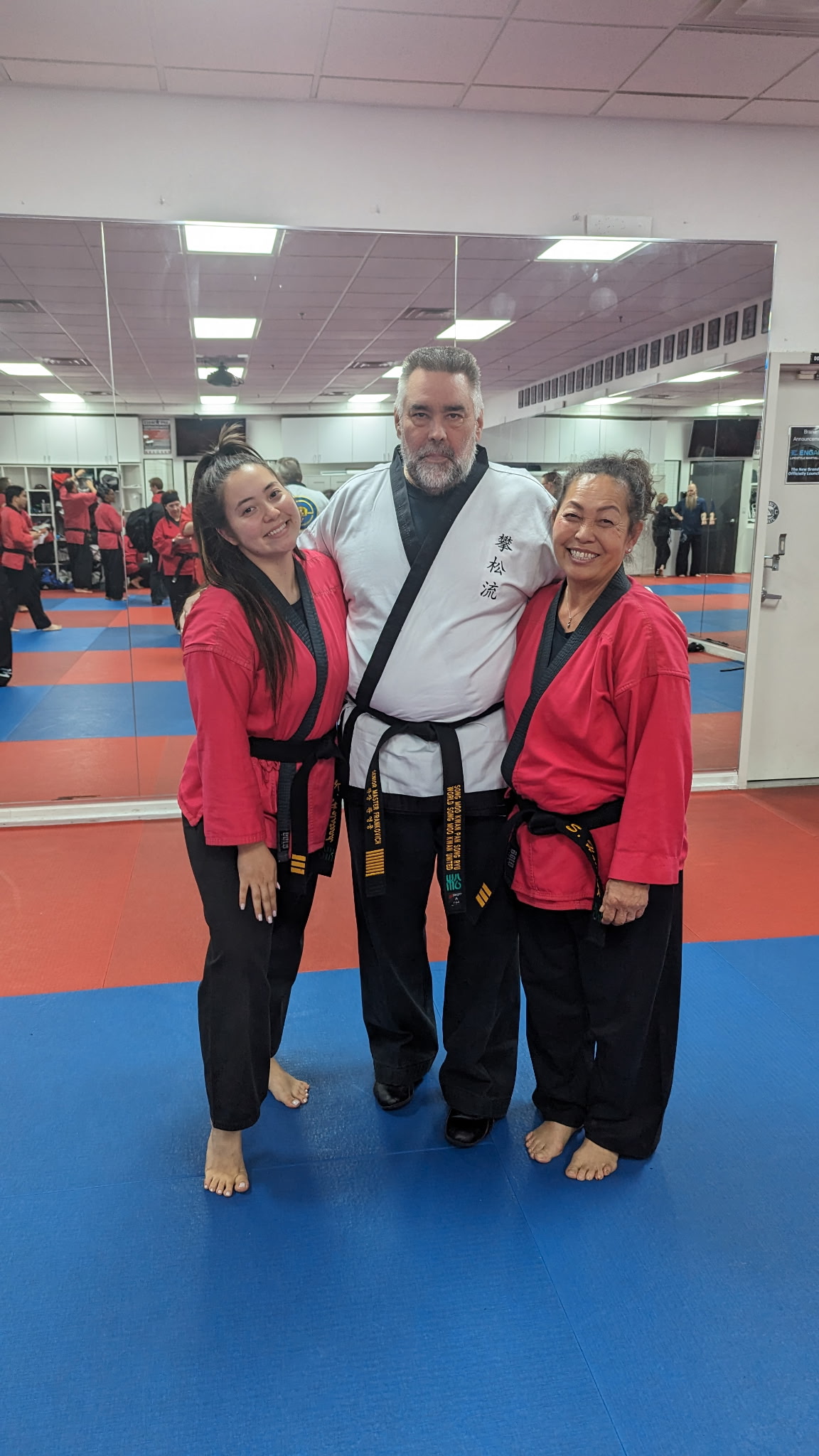 Kristen with martial arts instructor and another student