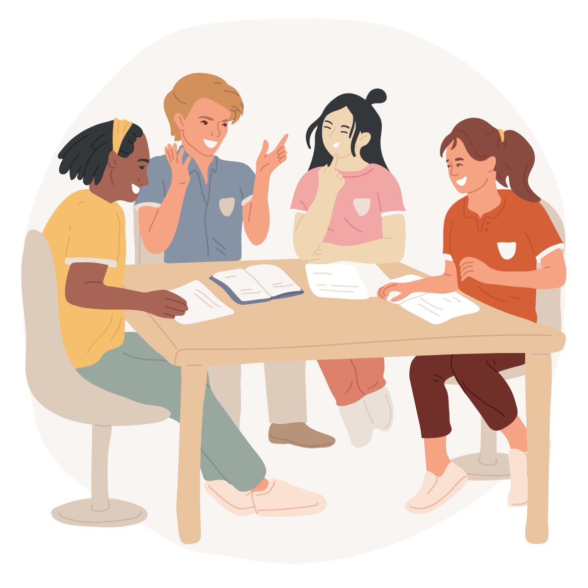 Four people sitting around a table discussing work happily