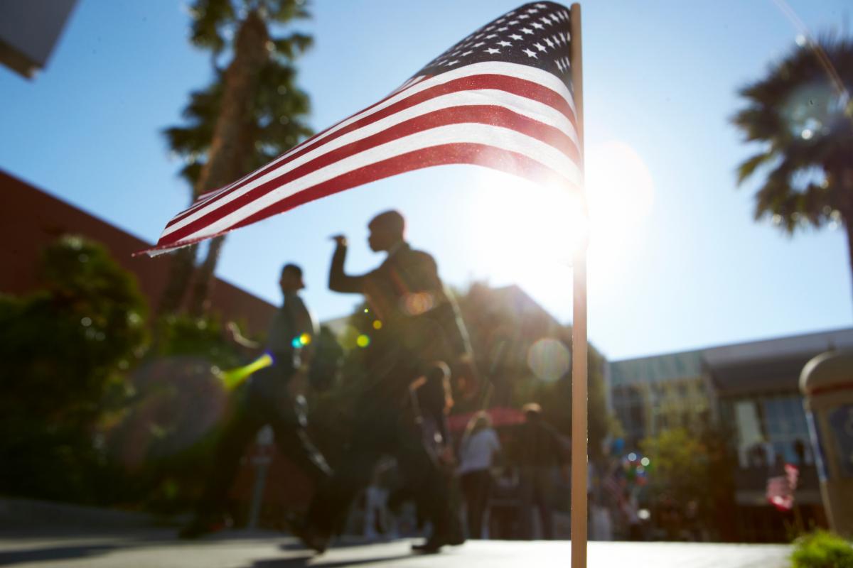 American flag with people in the background on UNLV campus