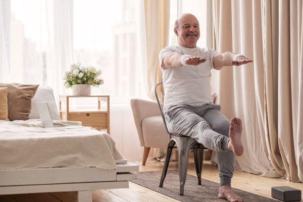 Man doing yoga in chair
