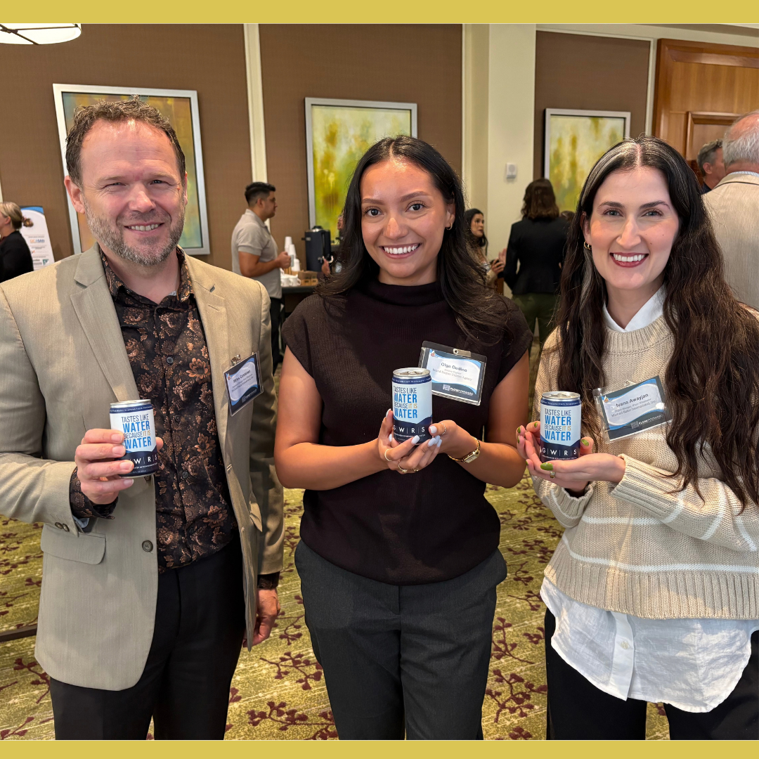 Picture from the OC Water Summit of 3 people hosting GWRS canned water