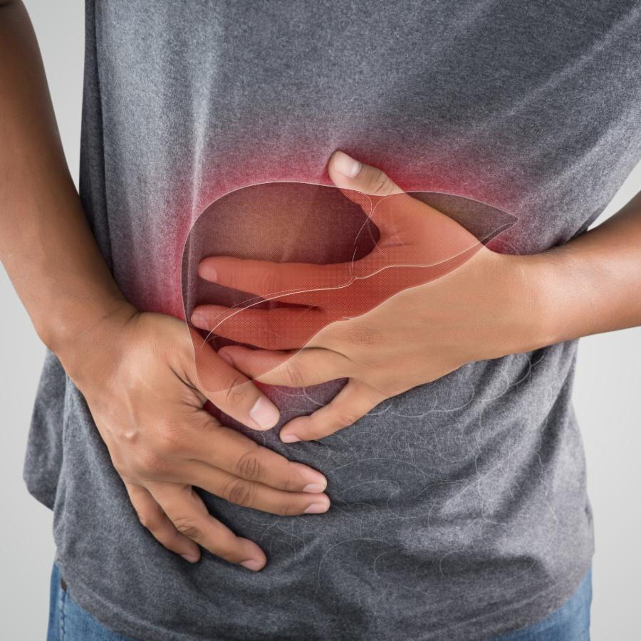 Male in gray t-shirt grabs stomach in pain with red glowing liver hovers over abdomen