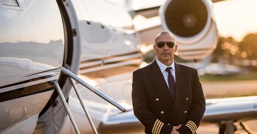 pilot standing next to the private jet