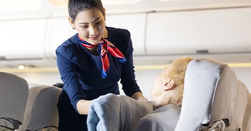 flight attendant helping passenger
