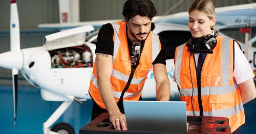 aviation engineers checking airplane data on laptop