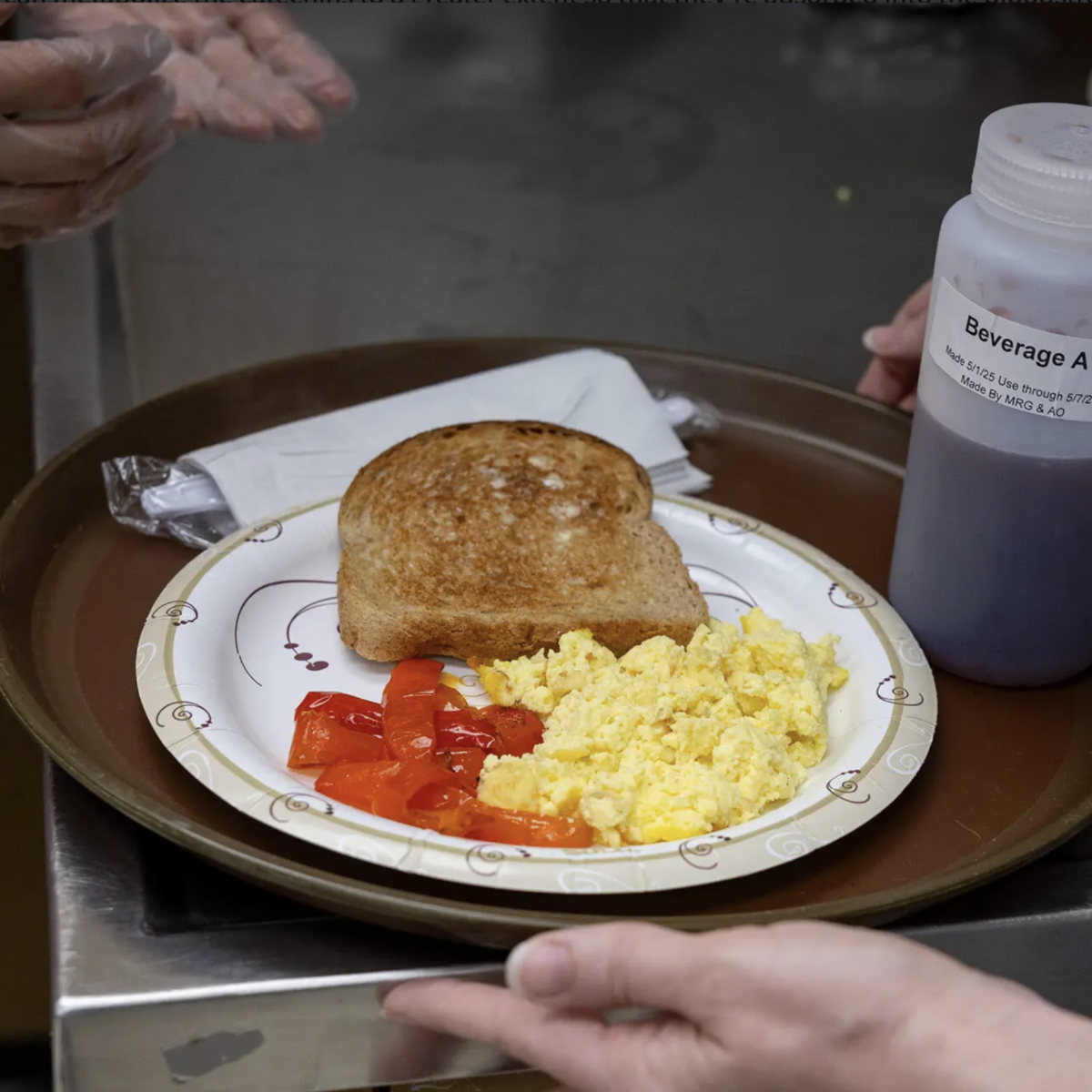 plate of scrambled eggs, roasted peppers and buttered toast