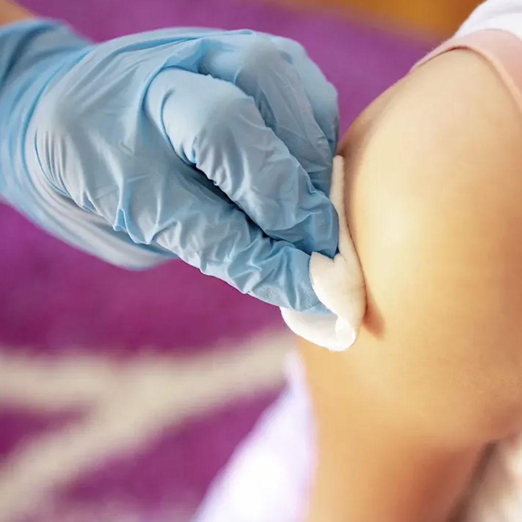 an arm being prepared for a vaccine