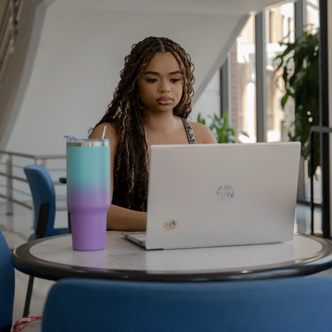 black female student working at laptop