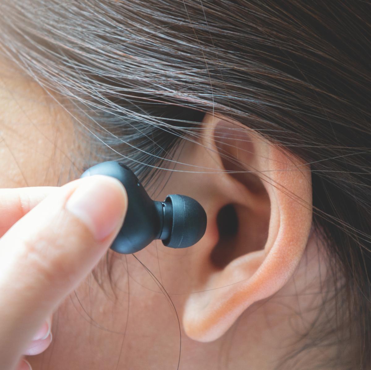 earbud being placed in ear