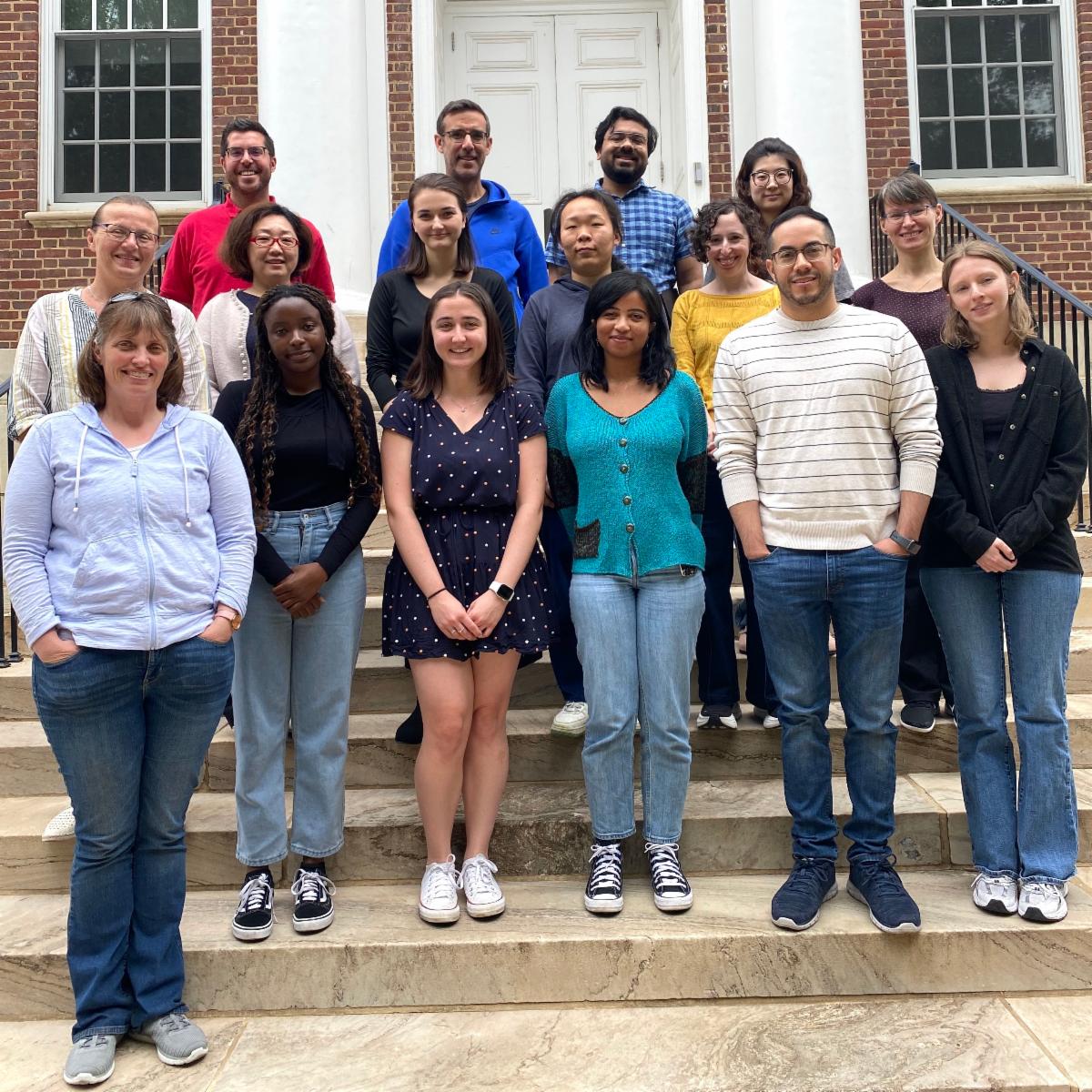 16 researchers posing as group on stairs