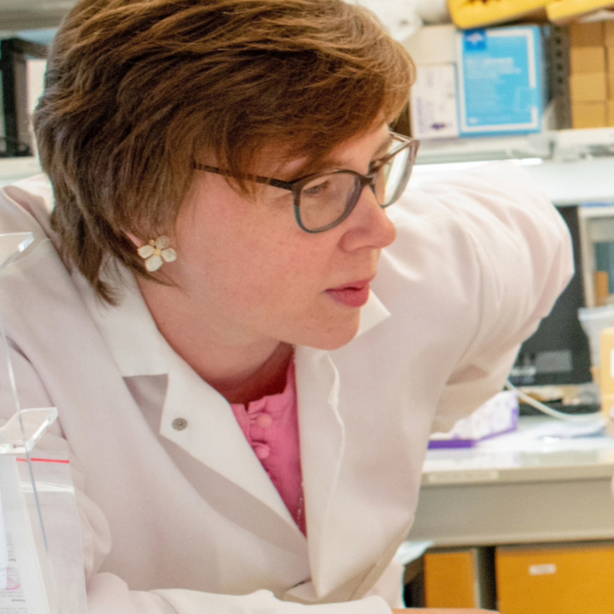 Katharina Maisel in white lab coat and glasses