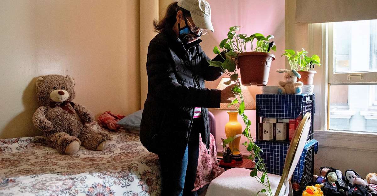 Woman in her room tending to plants