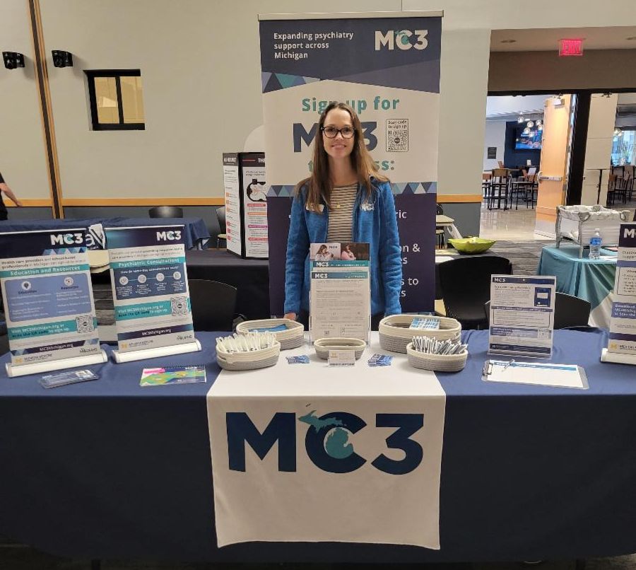 Jessica Jenkins stands at an exhibit table.