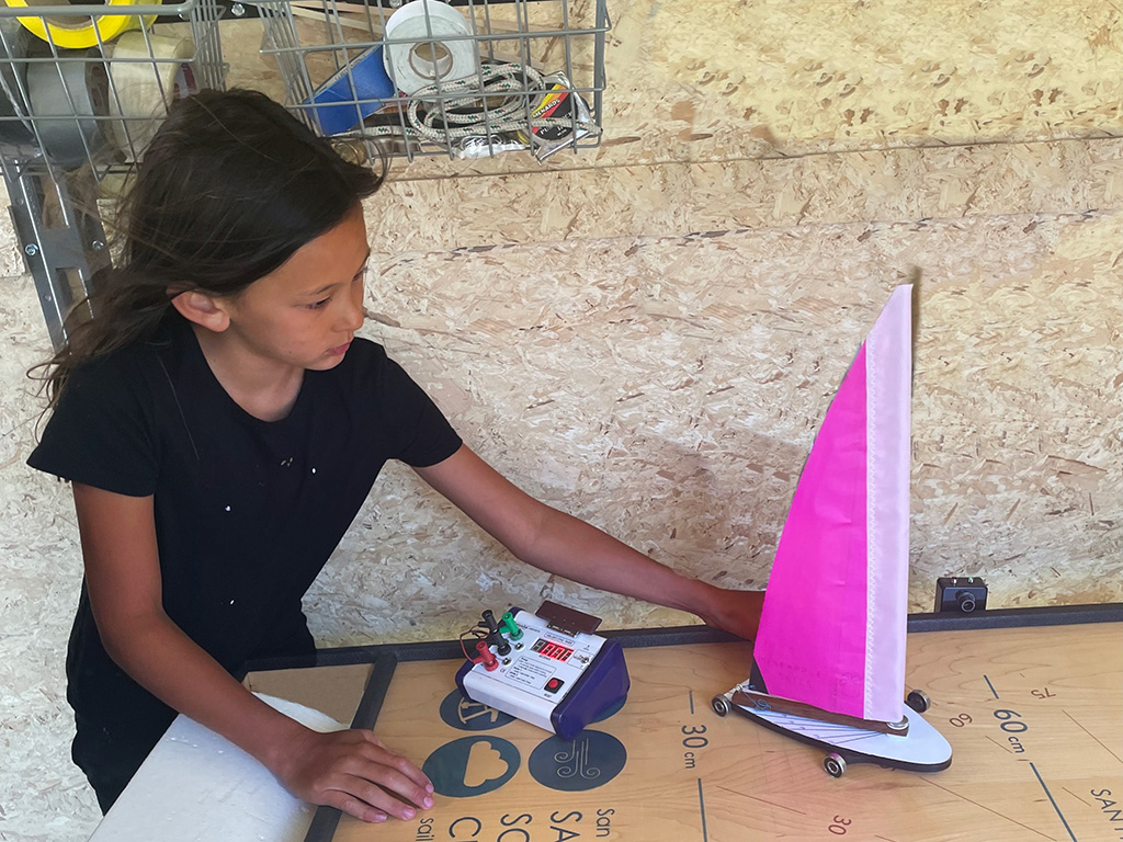 Young scientist playing with a Land Yacht