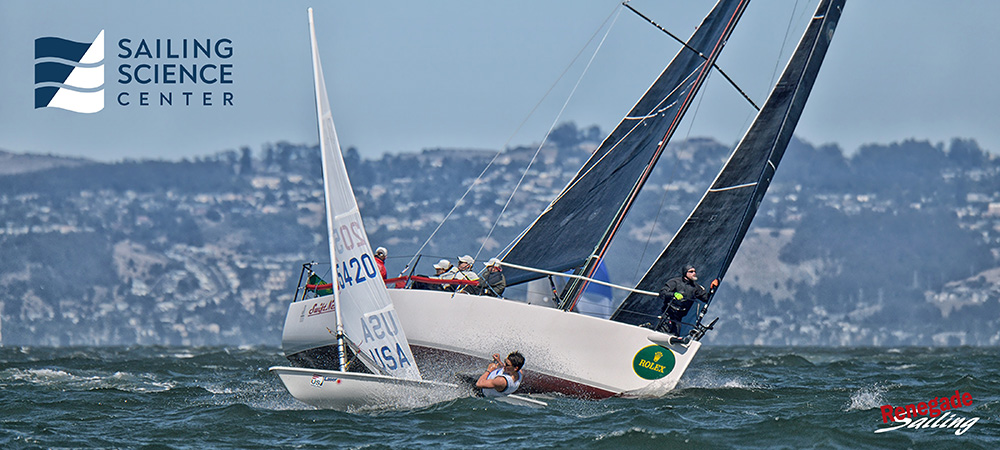 Reuben Rocci's J111 Swift Ness crosses tacks with a Laser during the 2018 Big Boat Series