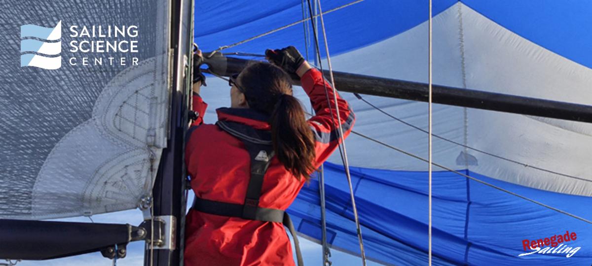 A woman setting a spinnaker pole