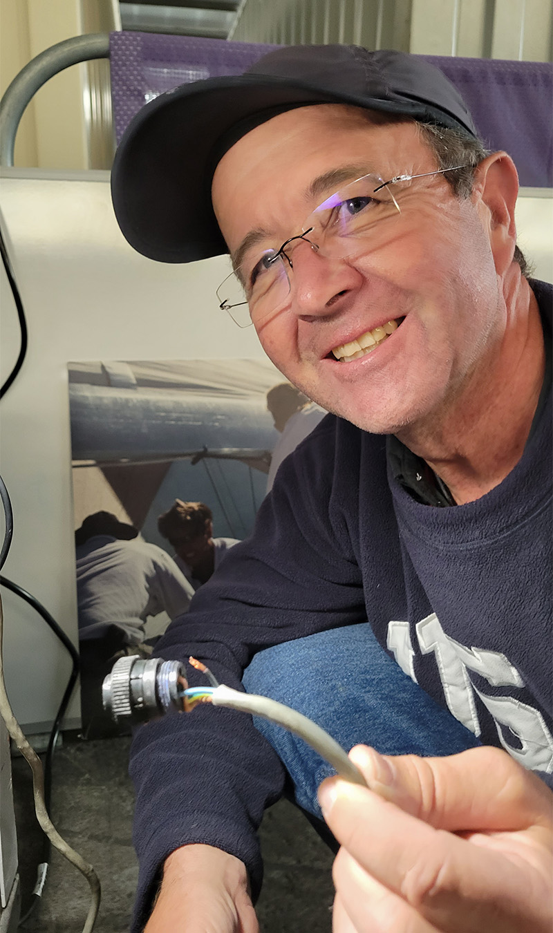 Chris Davis holding a broken connector from the grinder