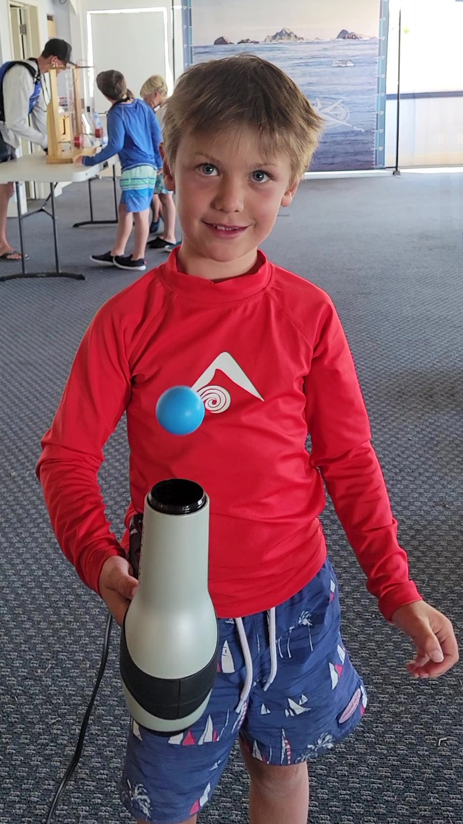 Boy balancing a Bernoulli Ball