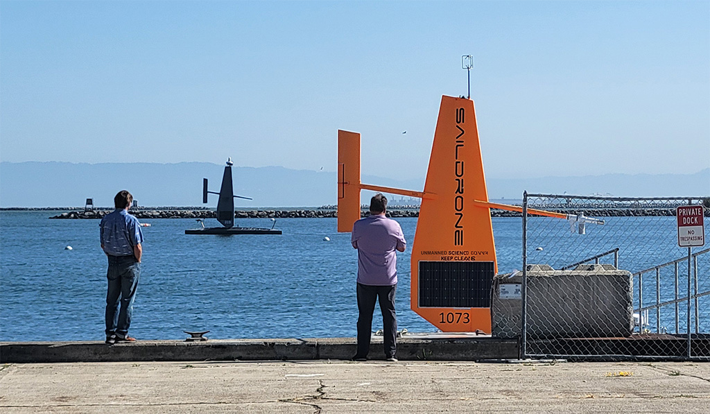 Fred King and Chris Fehring looking out at Saildrones on the water