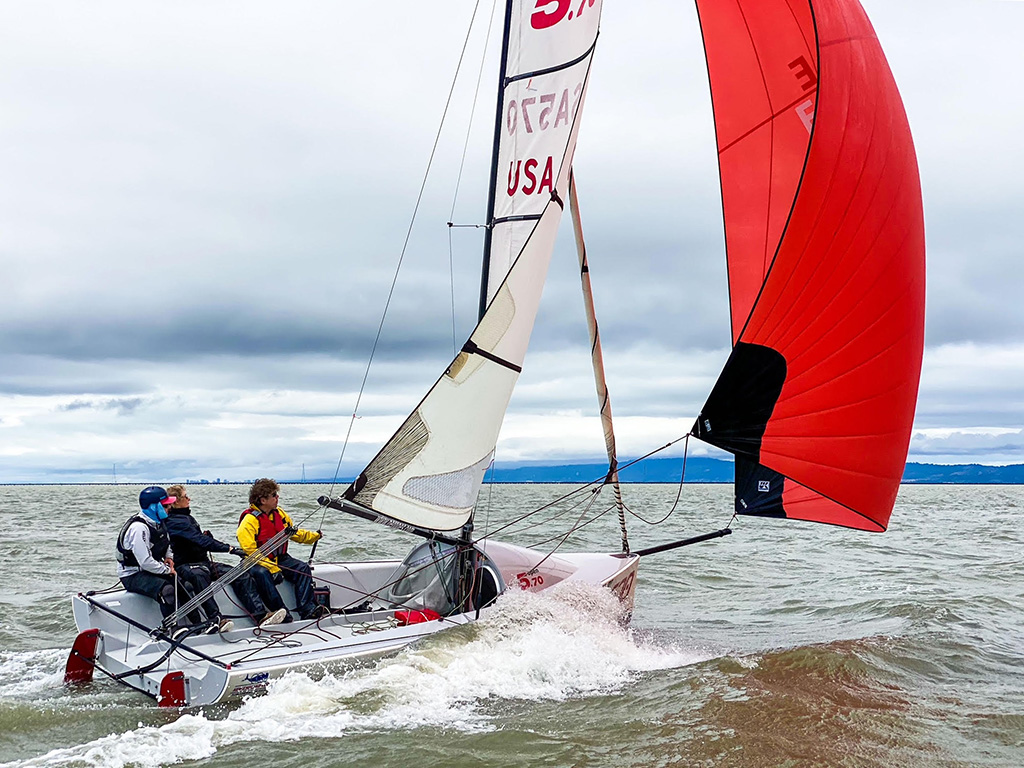 Maggie Heilman trimming the spinnaker on her Open 570