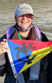 Alice Watts holding an IYC burgee