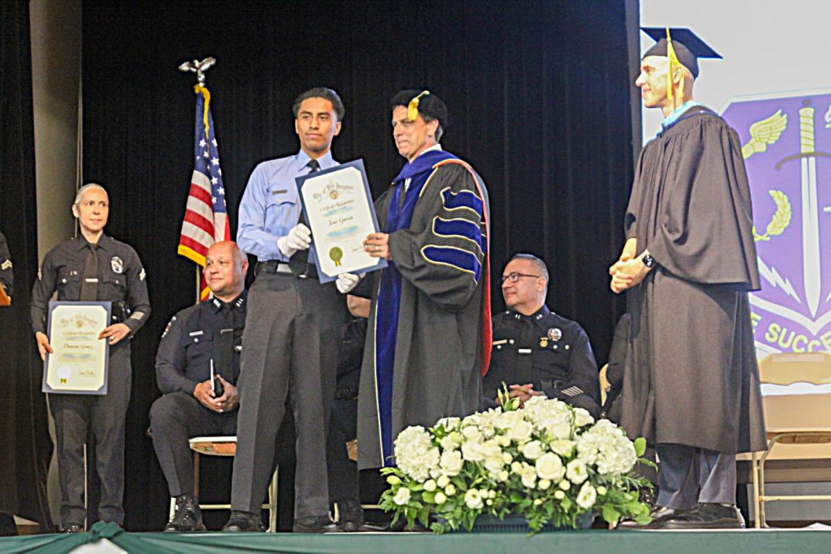 LAVC POPP Valedictorian Jesus Garcia receives his Certificate of Recognition from the City of Los Angeles and LAVC President Dr. Barry Gribbons at the POPP Graduation.
