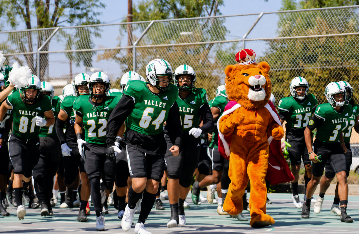 LAVC Mascot Leo the Lion runs out with Football Team