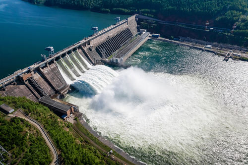 Hydroelectric dam on the river_ water discharge from the reservoir_ aerial photography