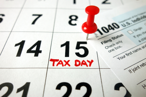 Calendar showing date April 15 2020 with 1040 form_ tax day in USA concept