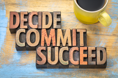 Decide_ commit_ succeed word abstract in vintage letterpress wood type with a cup of coffee
