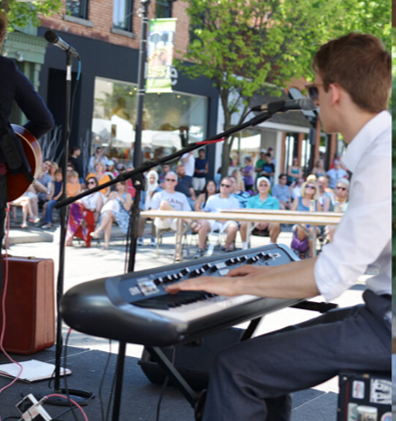 Musician with short hair play keyboard on an outdoor stage at a previous year's Maple & Main Festival