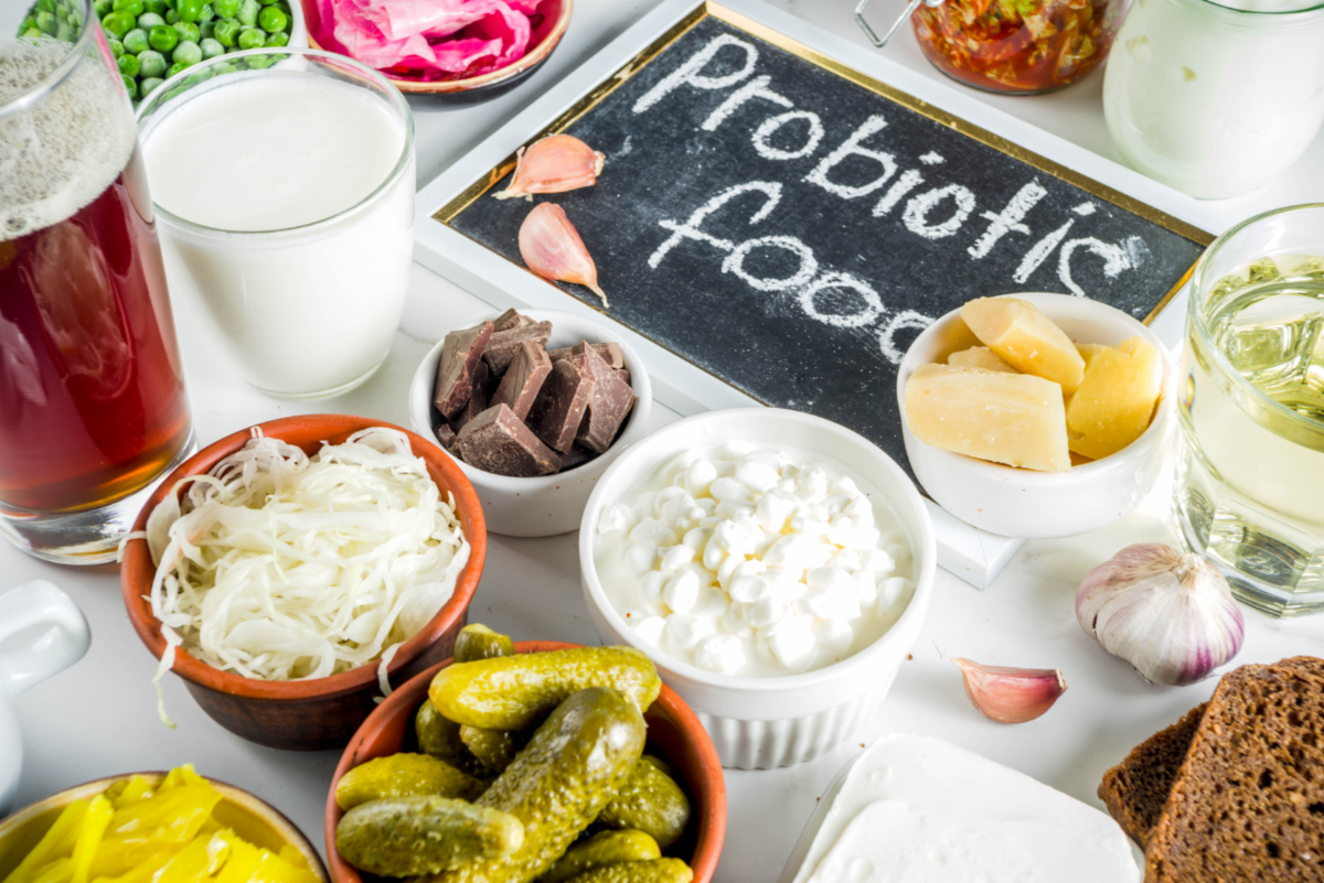 Sign with words Probiotic Foods surrounded by various foods in dishes