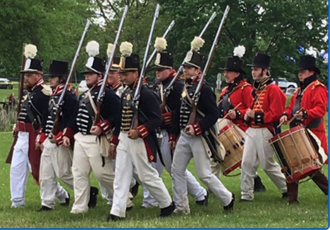 War of 1813 Re-enactors marching in period costumes with period weapons