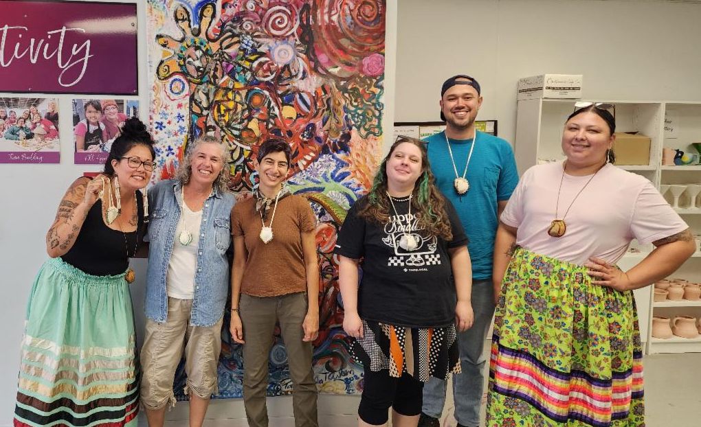 Photo of SEMAC staff with the Honoring Dakota Project standing in a row smiling and facing the camera.